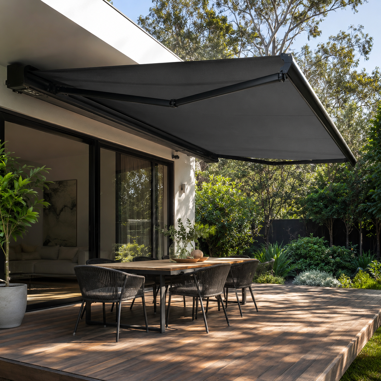Folding arm awning extended over a modern Melbourne deck and outdoor dining area.